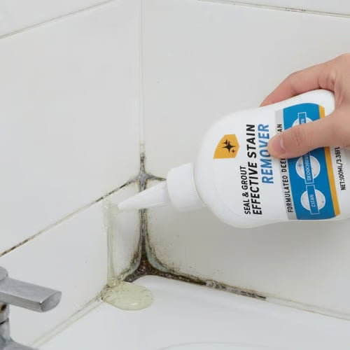 Applying stain remover gel to bathroom grout